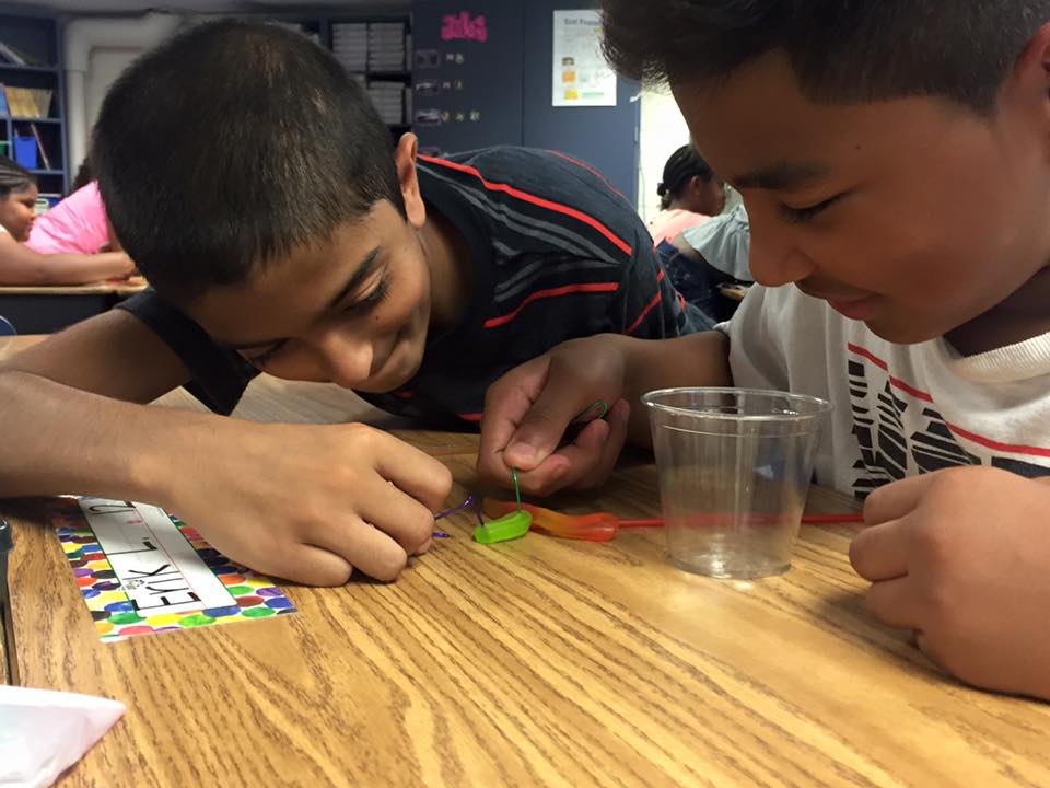 two boys doing an experiment