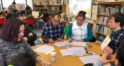 Ms. Guerrero working with Parents in the school library